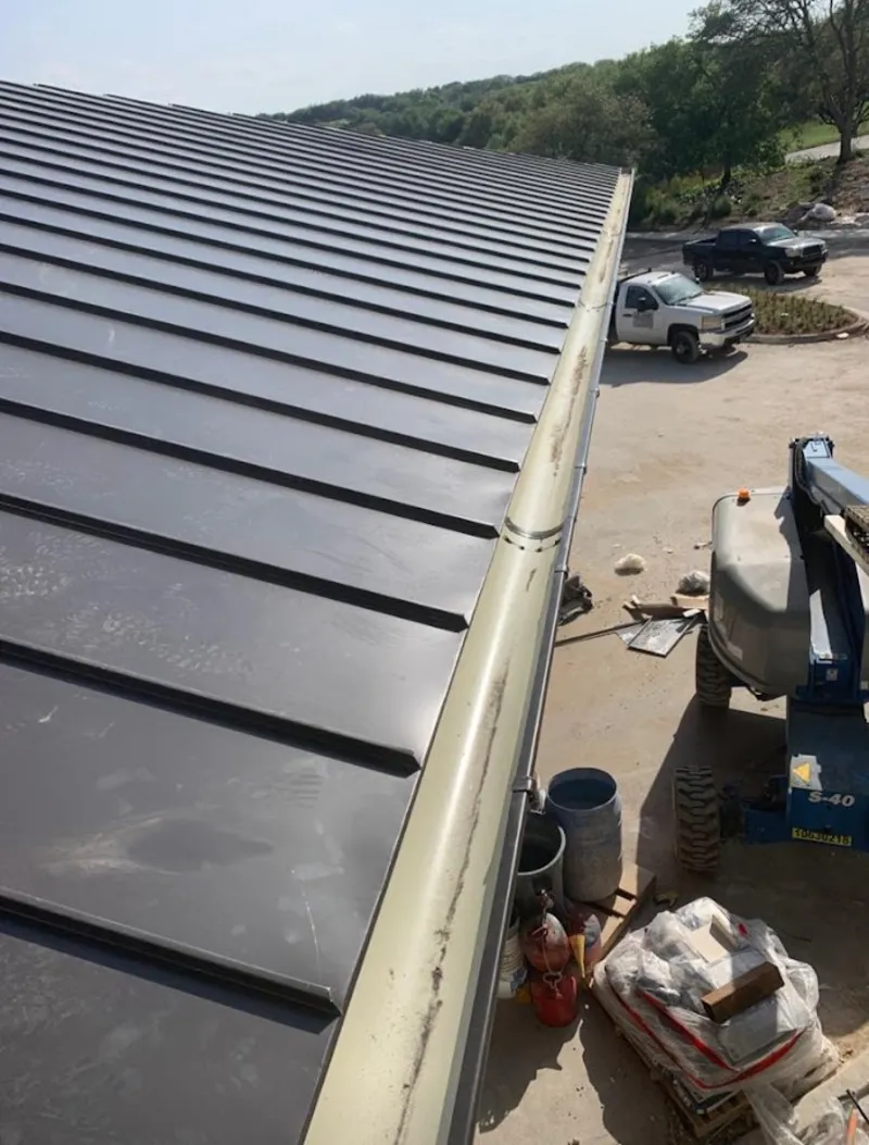 Standing seam panel and gutter detail on a metal roofing jobsite in Front Royal